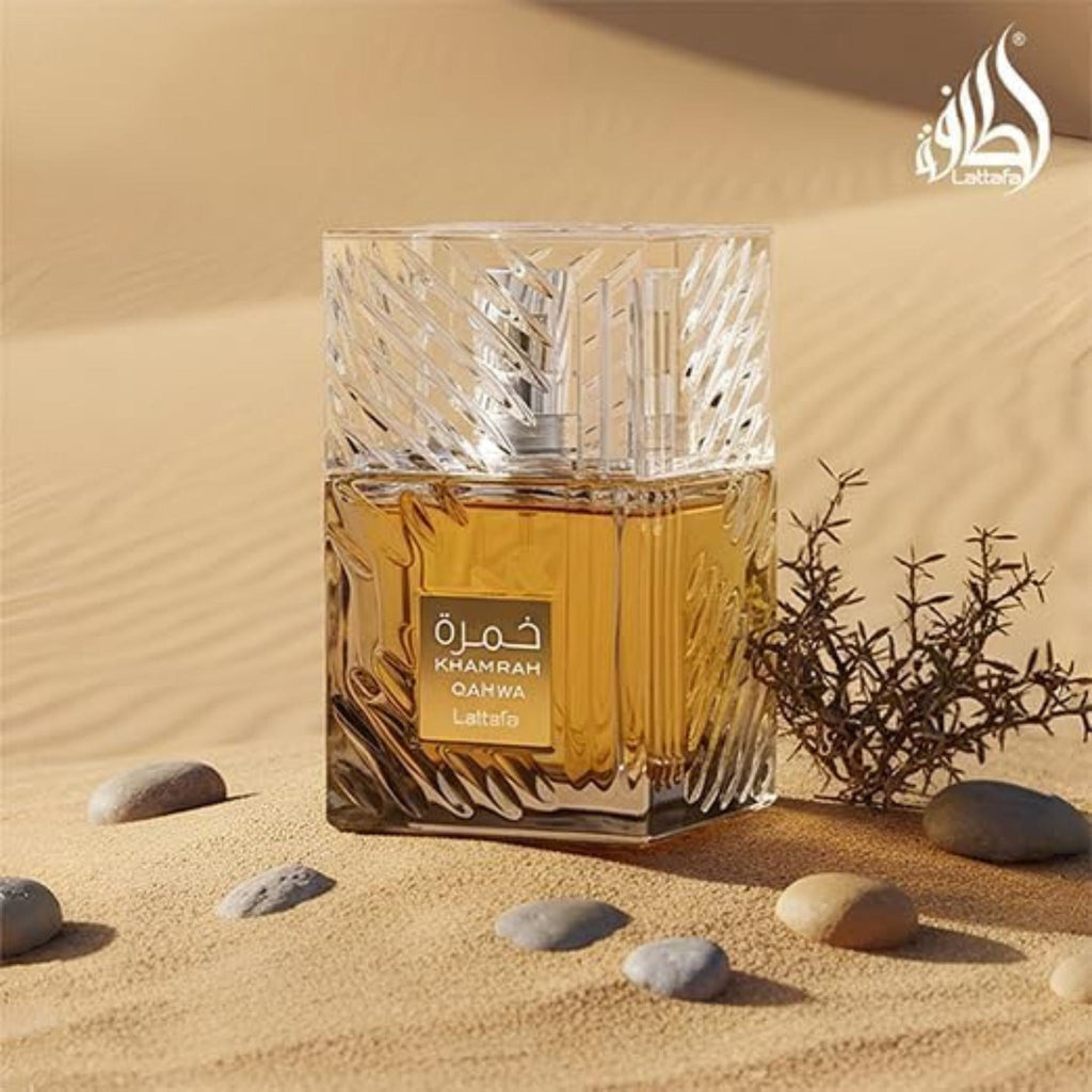 Refect Beauty Lattafa Khamrah Qahwa eau de parfum in a textured glass bottle set against a desert sand background.