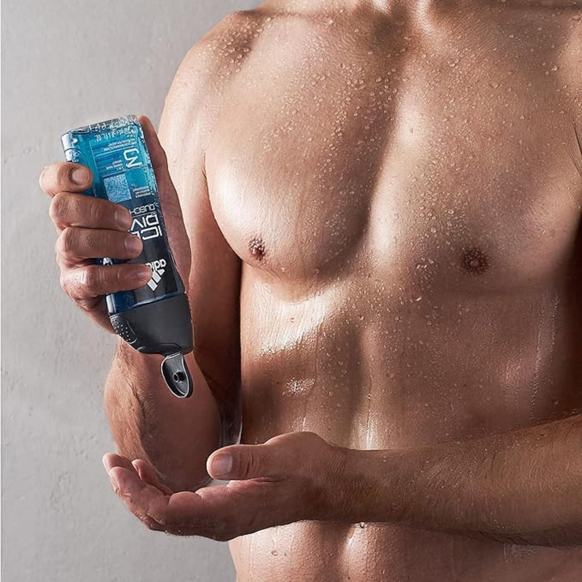 Refect Beauty Adidas Ice Dive shower gel held by a man in a shower for a refreshing post-workout cleanse