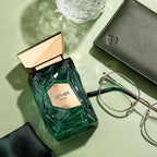 Refect Beauty French Avenue Aether extrait de parfum bottle with green faceted glass and gold cap on a desk