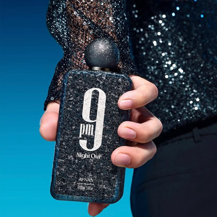 Refect Beauty Afnan 9 PM Night Out extrait de parfum bottle with a textured glittery finish held by a person