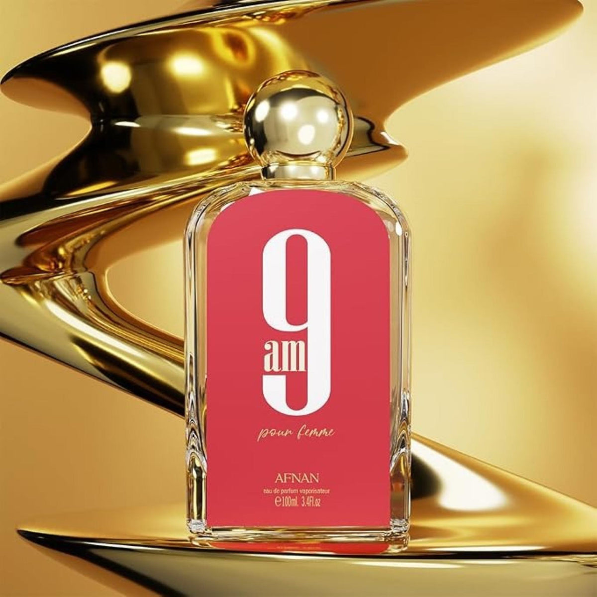 Refect Beauty Afnan 9AM Pink Femme eau de parfum bottle with a vibrant pink label against a golden abstract background.