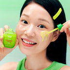 Refect Beauty model applying green Eqqualberry Aloe PDRN Calming Serum to her cheek for soothing skin care