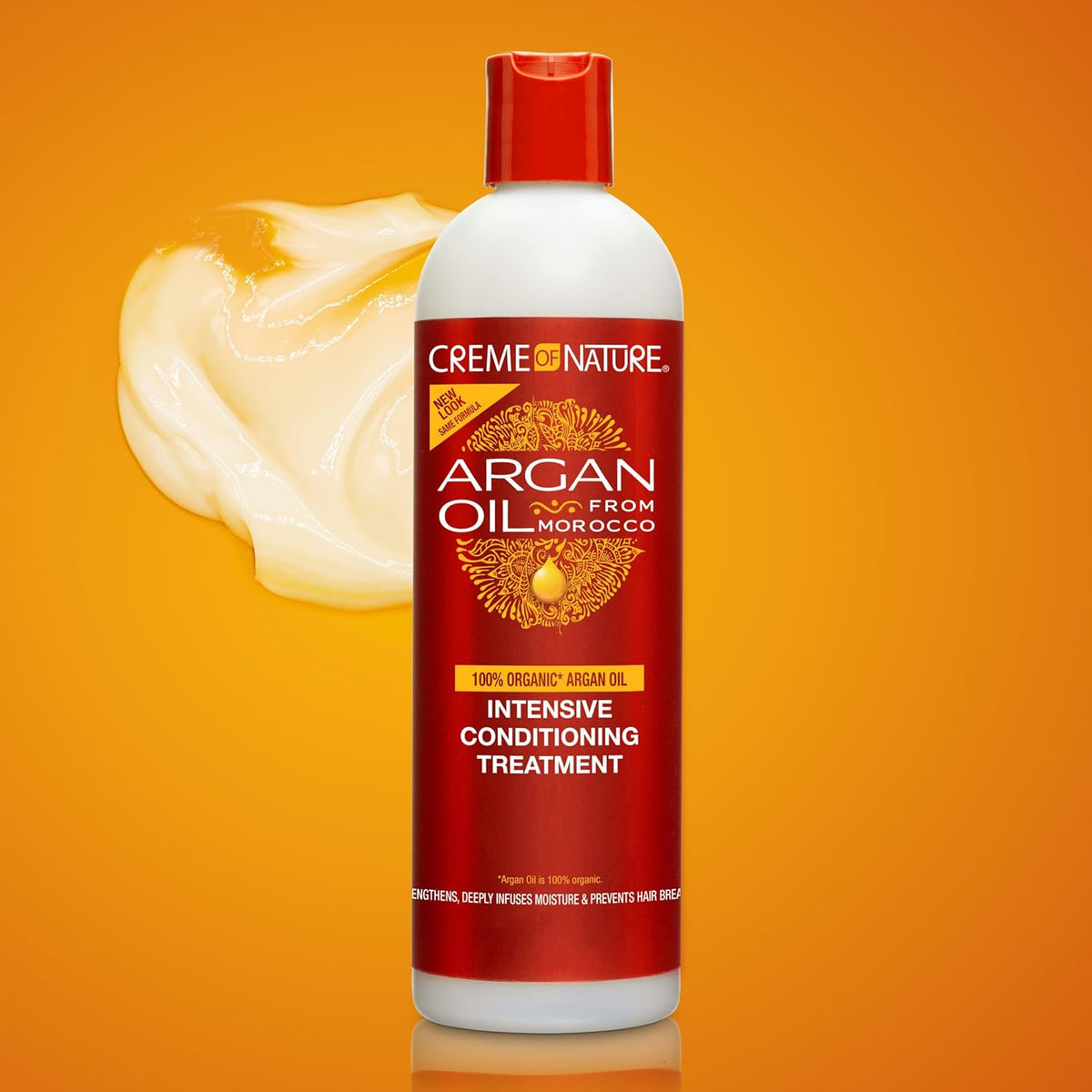 Refect Beauty Creme Of Nature Argan Oil Intensive Conditioning Treatment bottle with a dollop of cream on orange