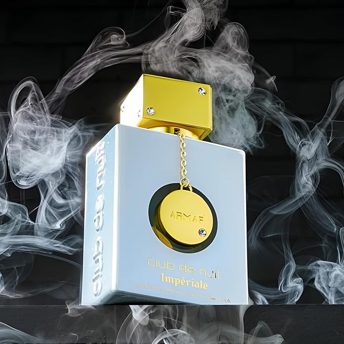 Refect Beauty Armaf Club De Nuit White Imperiale perfume bottle with gold cap and charm surrounded by wispy smoke