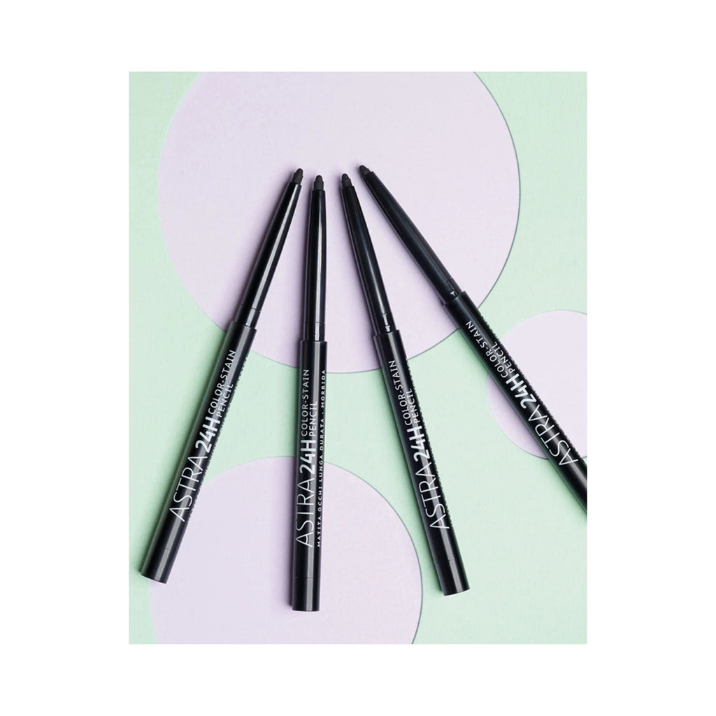 Refect Beauty Astra 24H Color Stain black kajal eye pencils arranged in a fan shape on a pastel geometric background