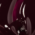 Refect Beauty Astra Lasting Gel Effect nail polish in a deep glossy burgundy shade with a high-shine finish.