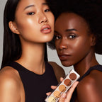 Refect Beauty Astra Conceal & Contour palette held by two diverse models with glowing, sculpted makeup looks