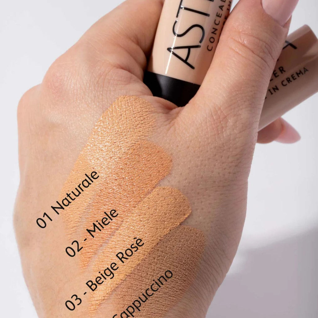 Refect Beauty Astra concealer cream stick showing four different skin tone swatches on a hand