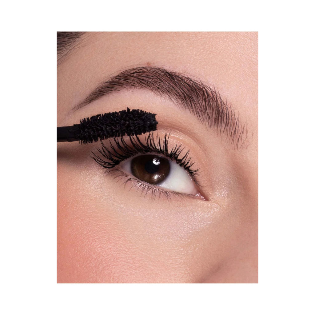 Refect Beauty Astra Curling Volume mascara wand applying black mascara to long, lifted eyelashes for a voluminous look.