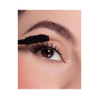 Refect Beauty Astra Curling Volume mascara wand applying black mascara to long, lifted eyelashes for a voluminous look.