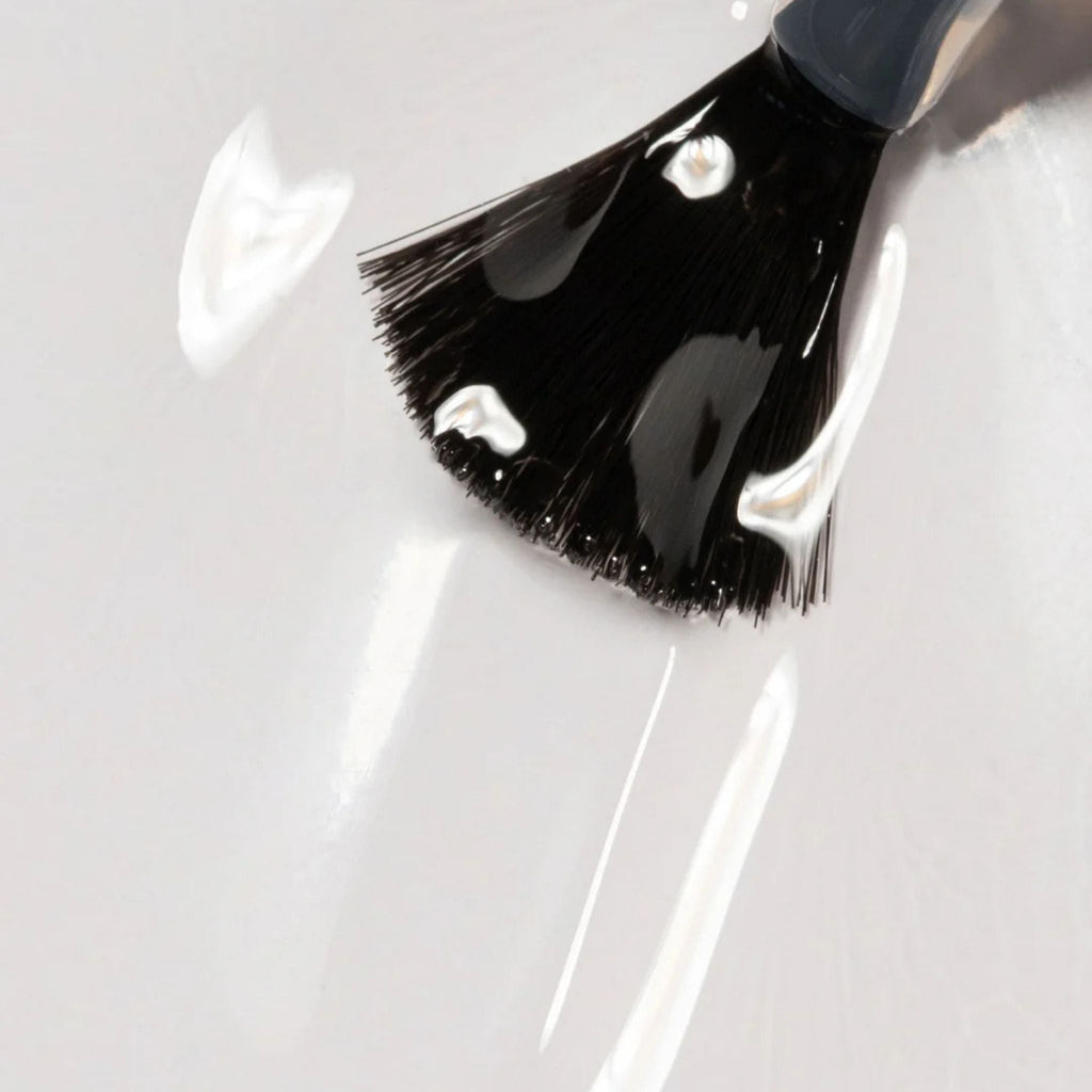 Refect Beauty Astra Lasting Gel Effect nail polish brush applying a glossy clear lacquer for a smooth gel finish.