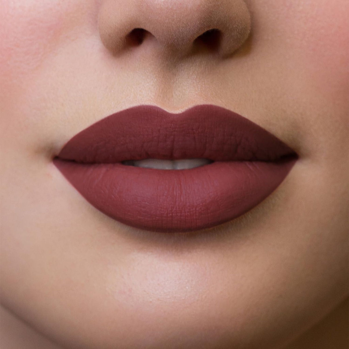 Refect Beauty Astra Hypnotize liquid lipstick in a deep matte berry shade applied on lips for a bold defined look