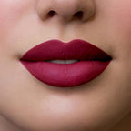 Refect Beauty Astra Hypnotize liquid lipstick in a deep matte berry red shade applied on lips for a bold look
