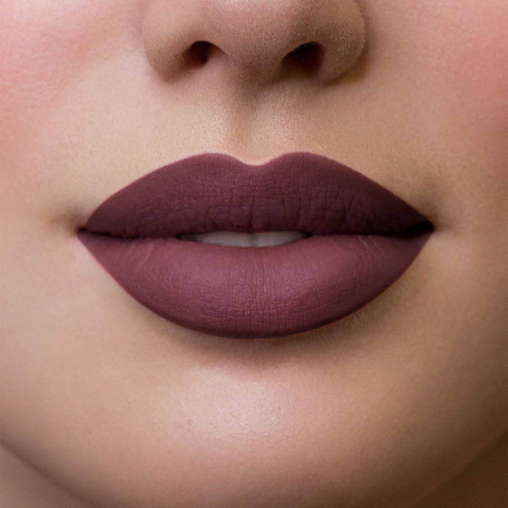 Refect Beauty Astra Hypnotize liquid lipstick in a deep matte plum shade applied on lips for a bold defined look