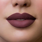 Refect Beauty Astra Hypnotize liquid lipstick in a deep matte plum shade applied on lips for a bold defined look