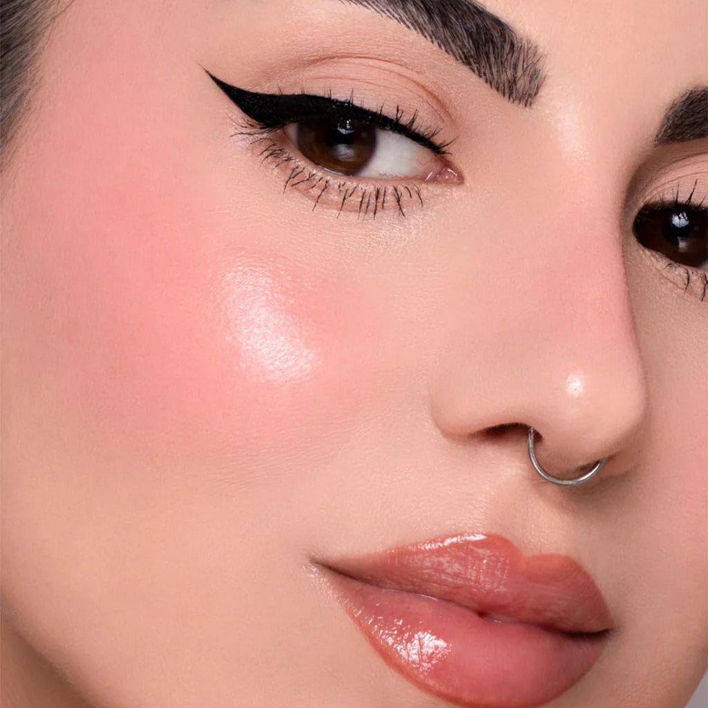 Refect Beauty Astra Identistick blush applied on a model's cheek for a radiant, natural cream-to-powder finish.