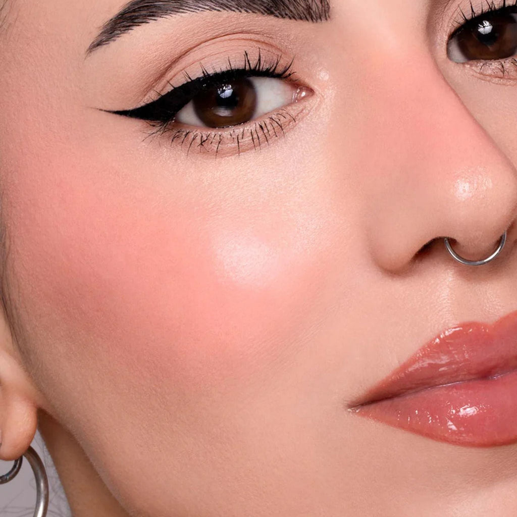 Refect Beauty Astra Identistick blush applied to a model's cheek for a natural, radiant, cream-to-powder finish.