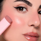Refect Beauty Astra Identistick blush stick being applied to a model's cheek for a natural cream-to-powder finish
