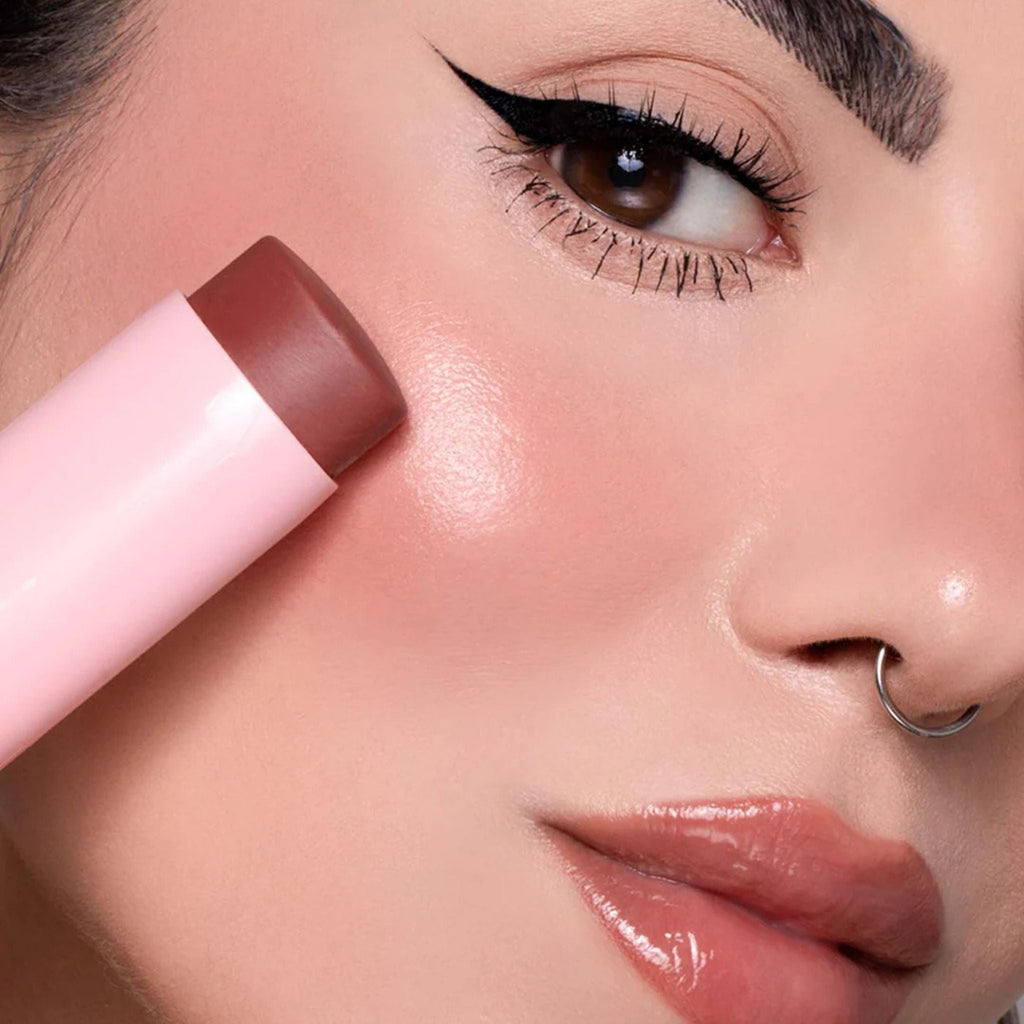 Refect Beauty Astra Identistick blush stick being applied to a model's cheek for a natural cream-to-powder finish.