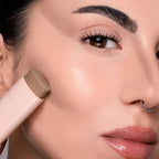 Refect Beauty Astra Identistick contour stick being applied to a model's cheekbone for a sculpted makeup look