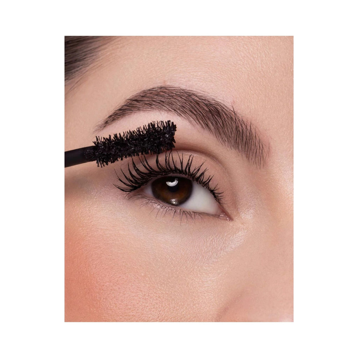 Refect Beauty Astra Instavolume mascara being applied with an hourglass fiber brush for volumized black lashes