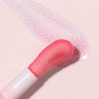 Refect Beauty Astra Pure Beauty Juicy Lip Oil applicator with a soft pink glossy texture on a light background