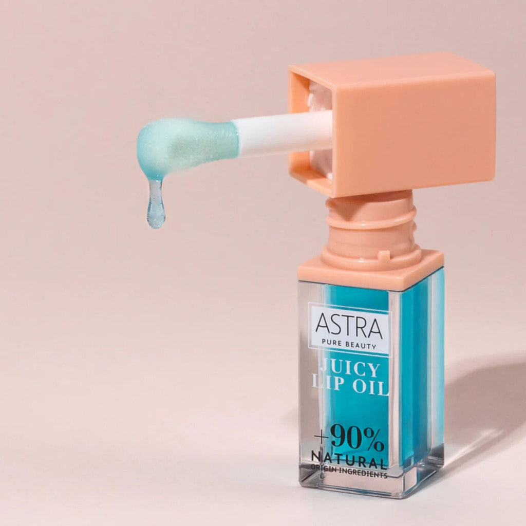 Refect Beauty Astra Pure Beauty Juicy Lip Oil in Forest Mint with a blue tint and applicator dripping product