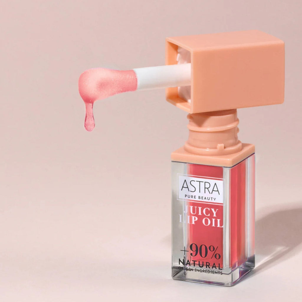 Refect Beauty Astra Pure Beauty Juicy Lip Oil in Peach shade with a glossy applicator dripping pink lip oil