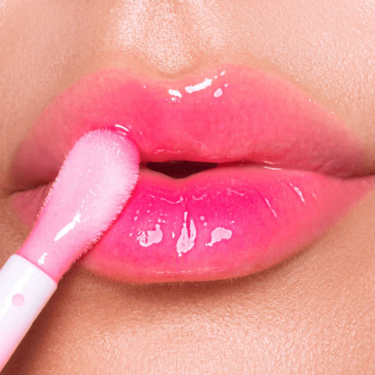 Refect Beauty Astra Pure Beauty Juicy Lip Oil in Peach 01 applied to lips with a soft applicator for a glossy finish