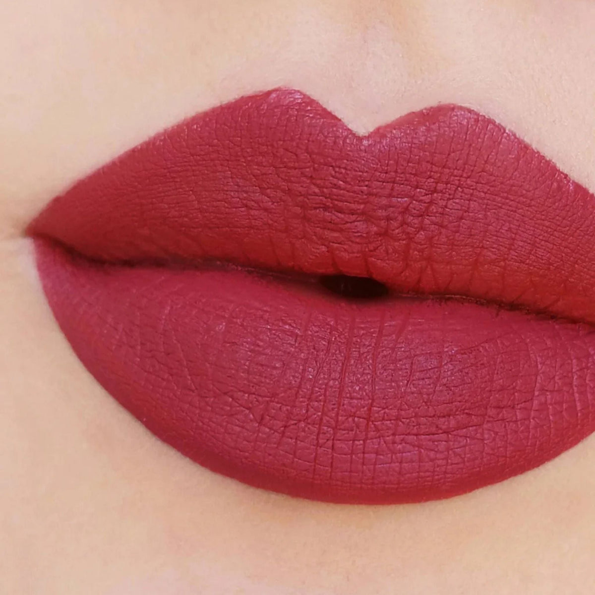 Refect Beauty Astra Jumbo Lipstick in a deep matte berry red shade applied to lips for a smooth defined finish