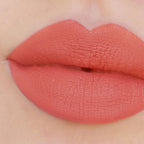 Refect Beauty Astra Jumbo Lipstick in a vibrant coral shade applied to lips for a smooth, matte finish.