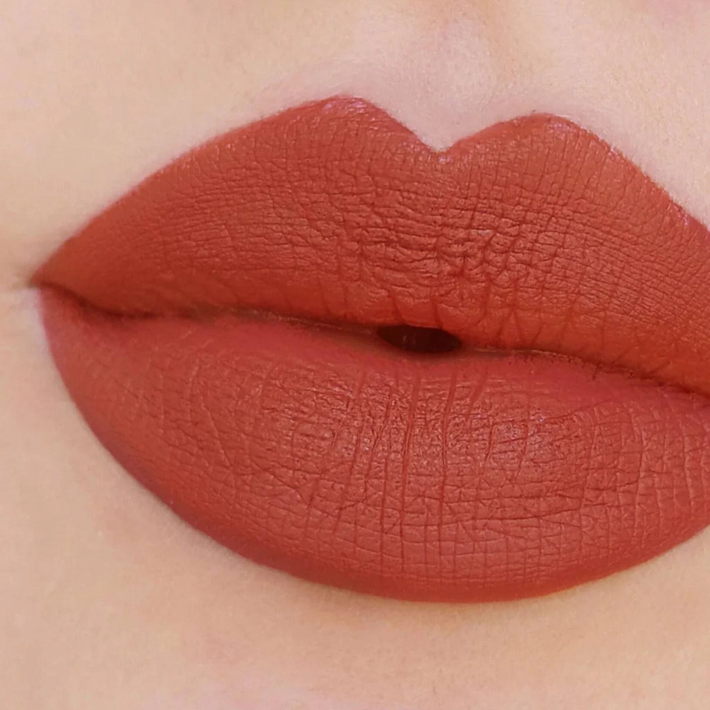 Refect Beauty Astra Jumbo Lipstick in a rich terracotta matte shade applied to lips for a smooth, defined finish.