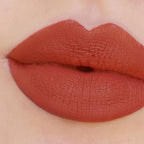Refect Beauty Astra Jumbo Lipstick in a rich terracotta matte shade applied to lips for a smooth, defined finish.