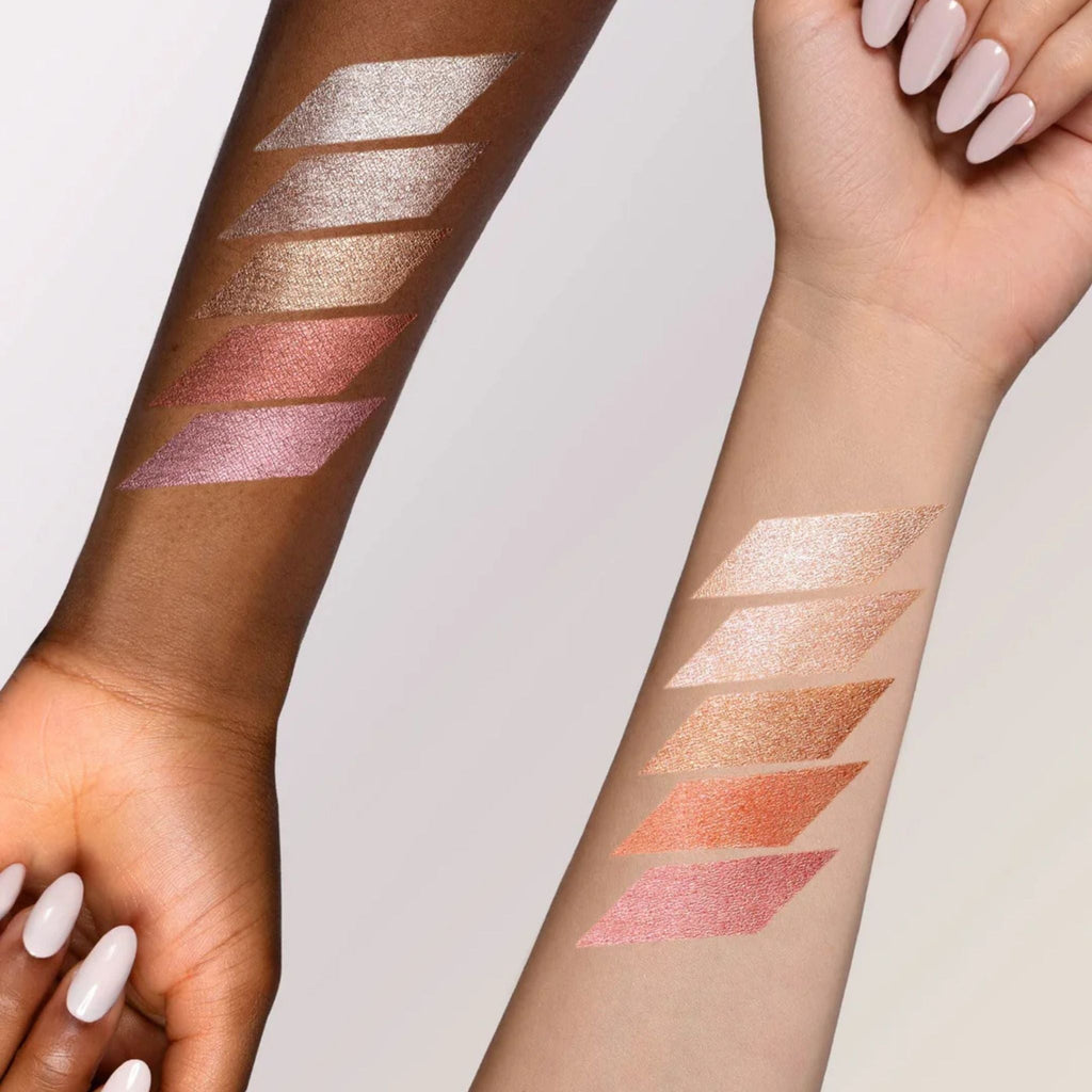 Refect Beauty Astra Light Therapy liquid highlighter swatches in various metallic shades on two different skin tones.