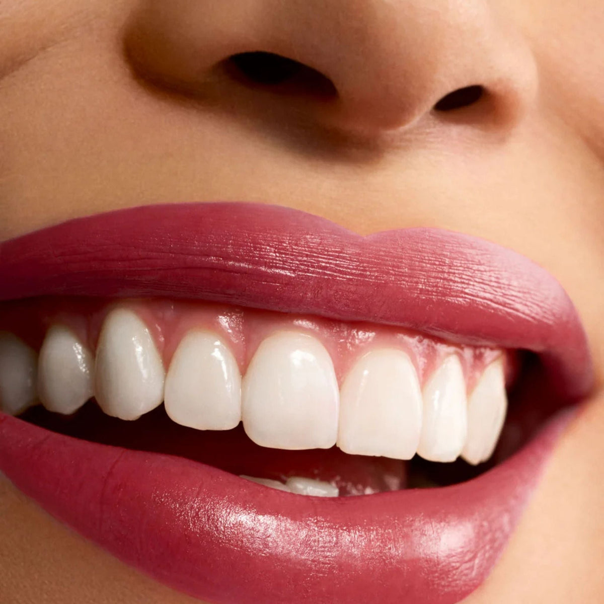 Refect Beauty Astra Lip Creamynal lipstick in a vibrant, luminous berry shade applied on smiling lips.