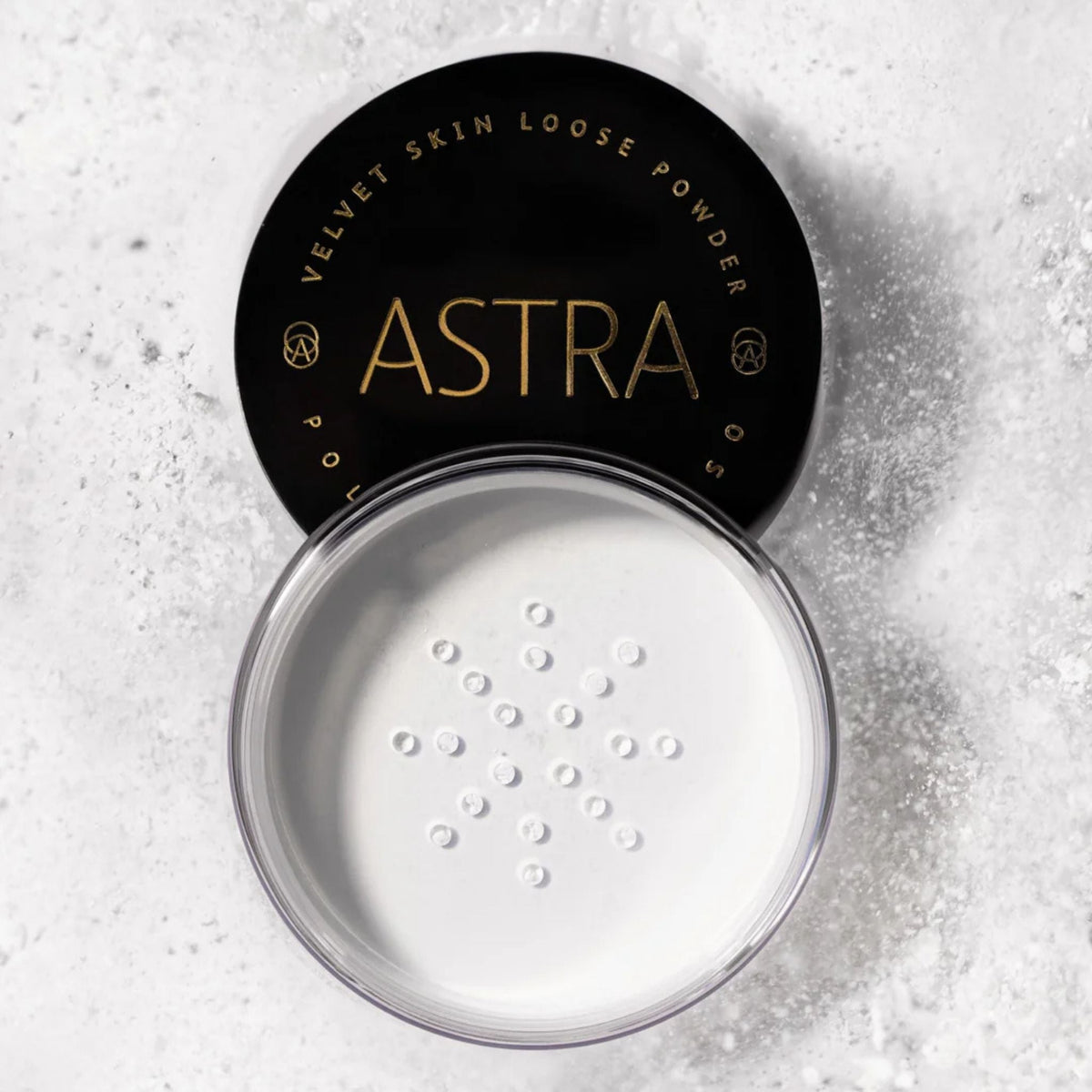 Refect Beauty Astra Velvet Skin loose translucent face powder in an open jar with a black lid on a textured surface