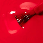 Refect Beauty Astra My Laque nail polish brush dipped in vibrant glossy red lacquer with a high-shine finish