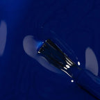 Refect Beauty Astra My Laque nail polish in a vibrant, glossy royal blue shade with an applicator brush