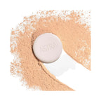 Refect Beauty Astra Natural Skin Powder in a compact case surrounded by loose beige face powder on a white background