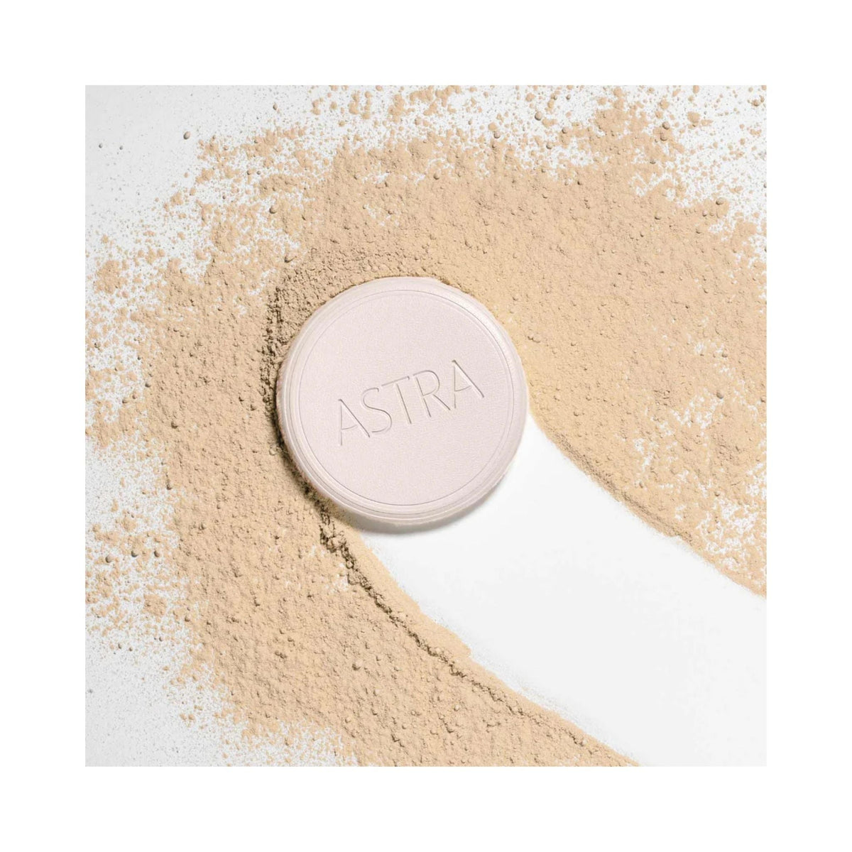 Refect Beauty Astra Natural Skin Powder in a compact case surrounded by loose beige face powder on a white background