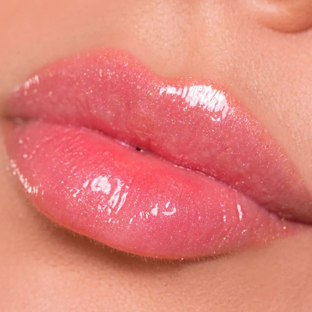 Refect Beauty Astra My Gloss Plump & Shine lip gloss on lips with a shimmering pink 3D finish and sparkling microbeads