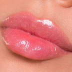Refect Beauty Astra My Gloss Plump & Shine lip gloss on lips with a shimmering pink 3D finish and sparkling microbeads