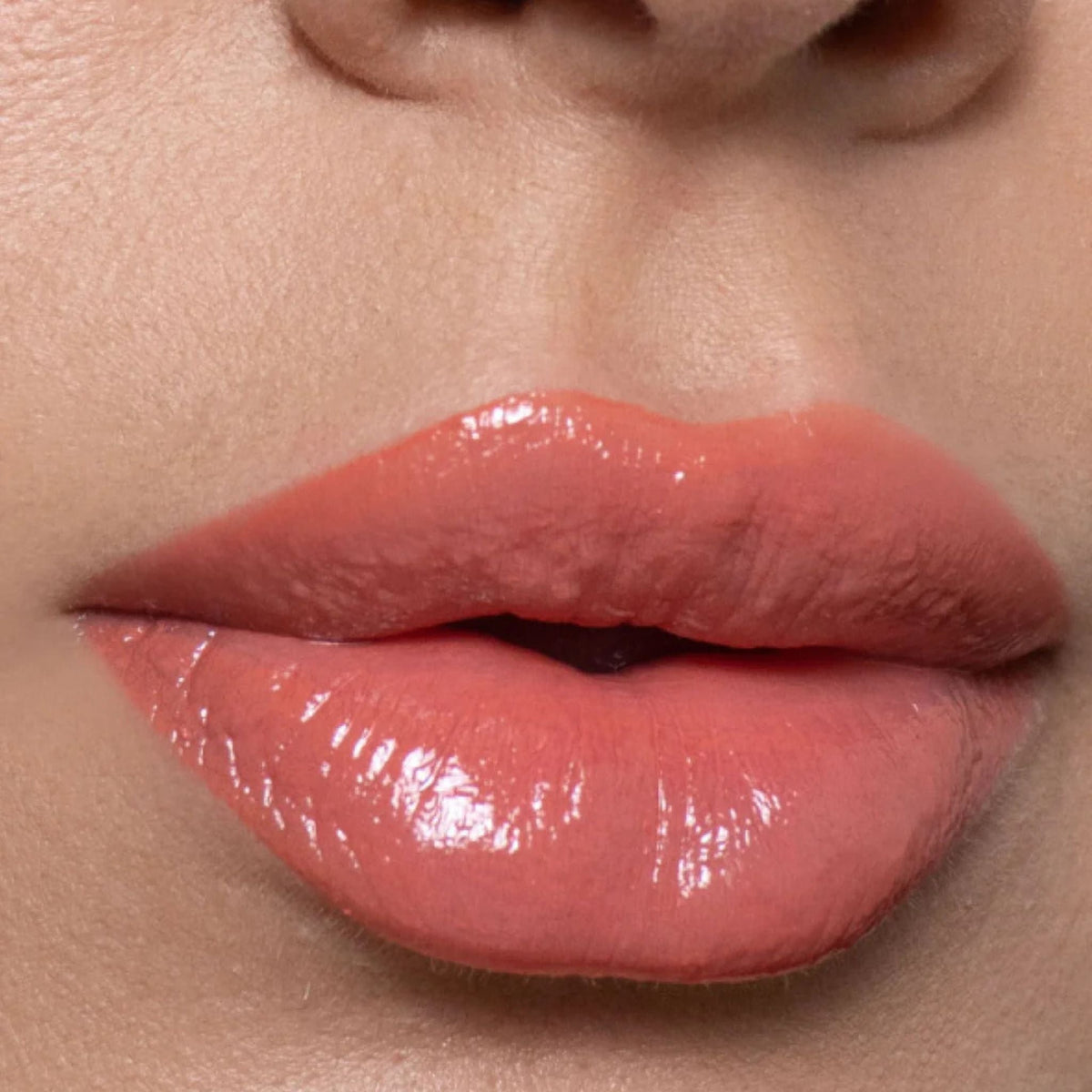 Refect Beauty Astra My Gloss Plump & Shine lip gloss in a glossy coral pink shade with a 3D reflective finish