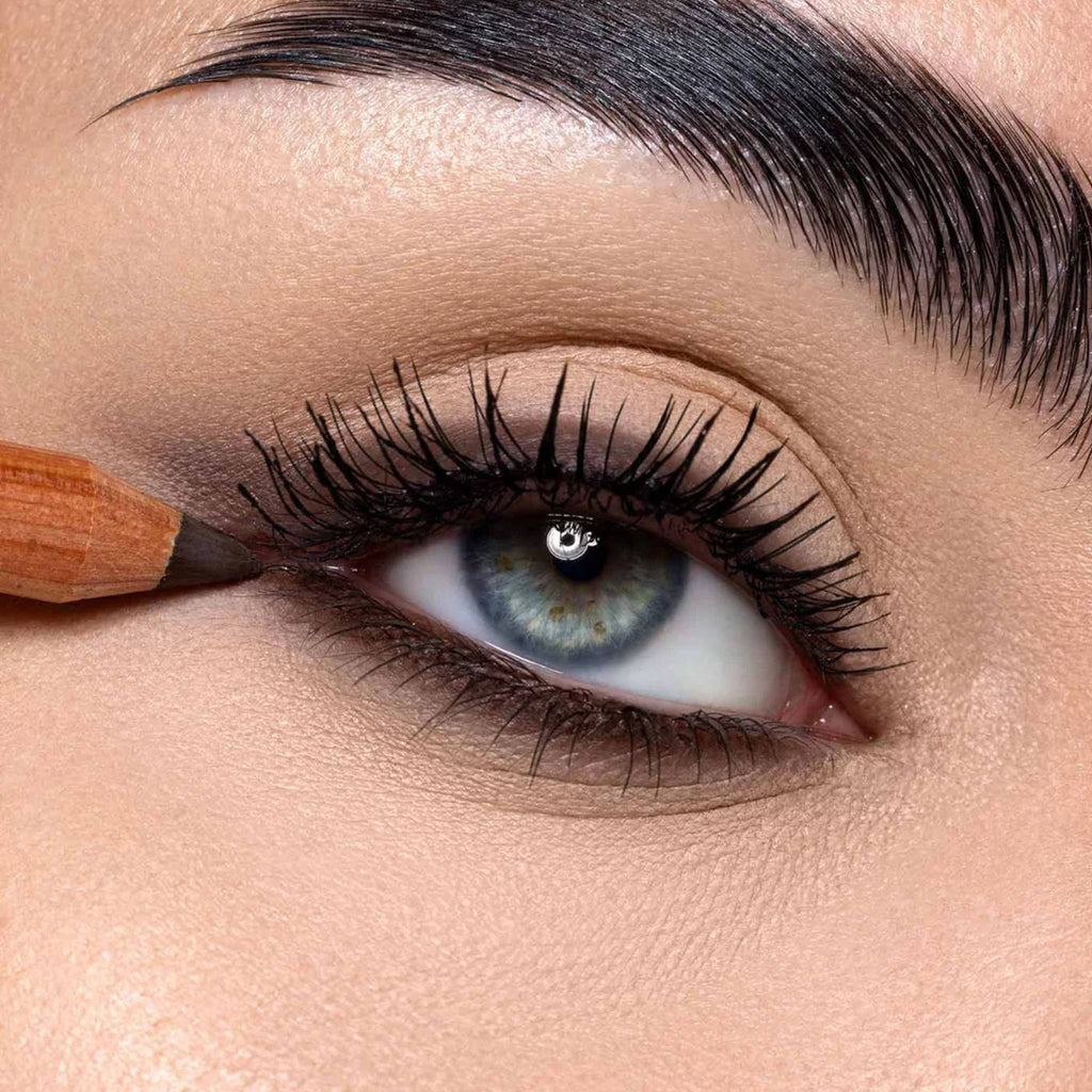 Refect Beauty Astra Pure Beauty Kajal eye pencil applying dark liner to the upper lash line of a blue eye