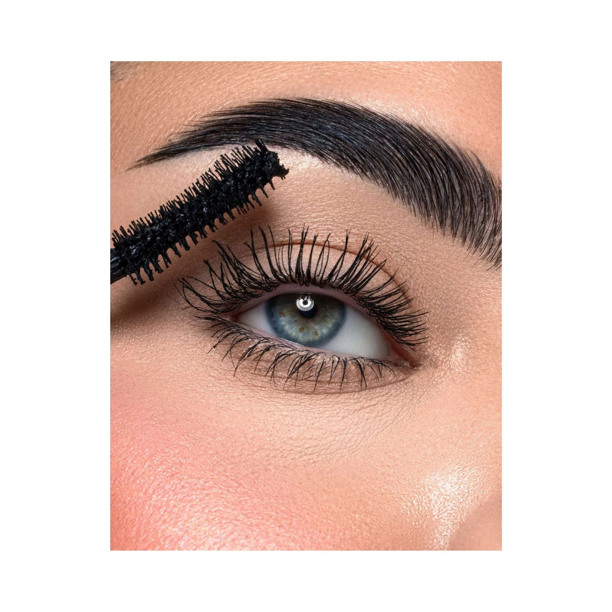 Refect Beauty Astra Subliminal Atomic Volume mascara wand applying black volumizing mascara to long eyelashes