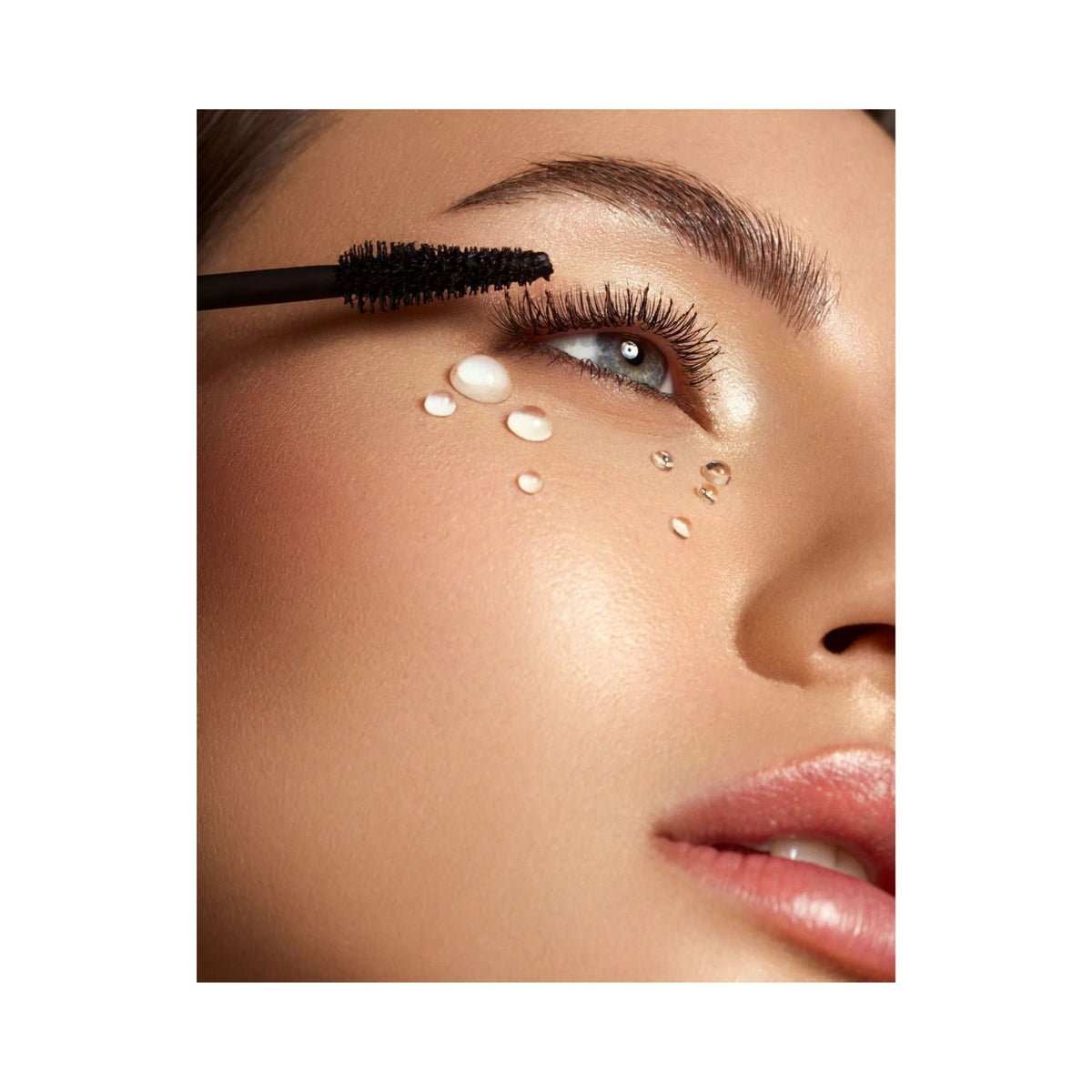 Refect Beauty Astra Subliminal X Volume Waterproof mascara being applied to lashes with water droplets on model face