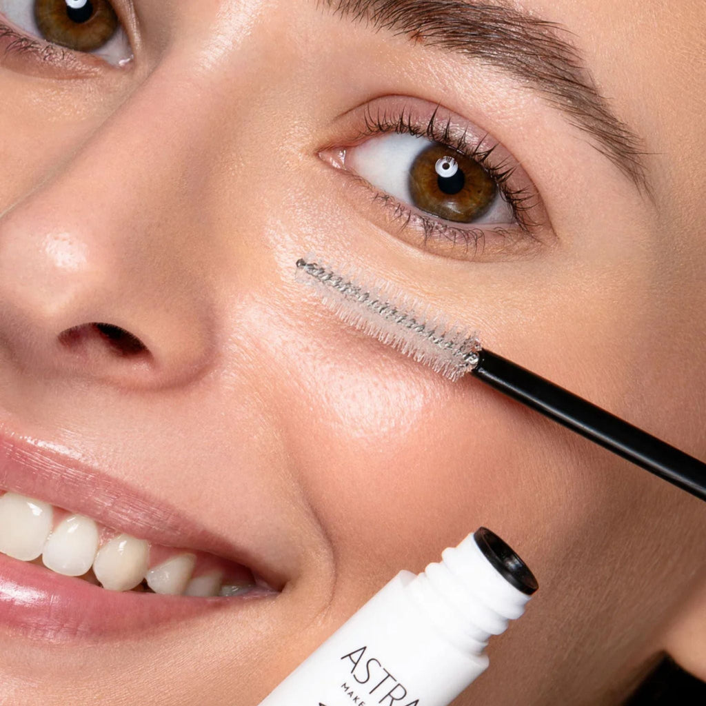 Refect Beauty Astra Zen Routine Fixing Mascara being applied to lashes by a smiling model with natural makeup