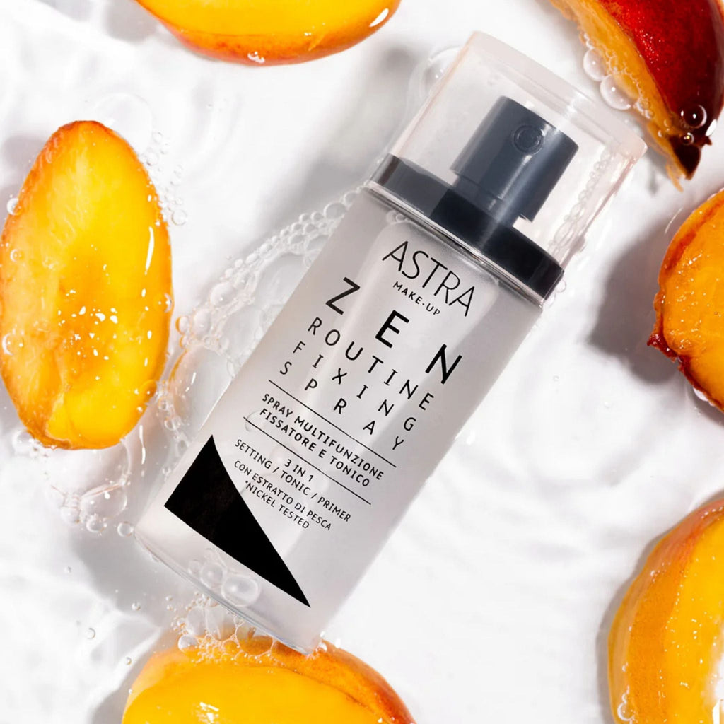Refect Beauty Astra Zen Routine Fixing Spray bottle surrounded by fresh peach slices and water droplets