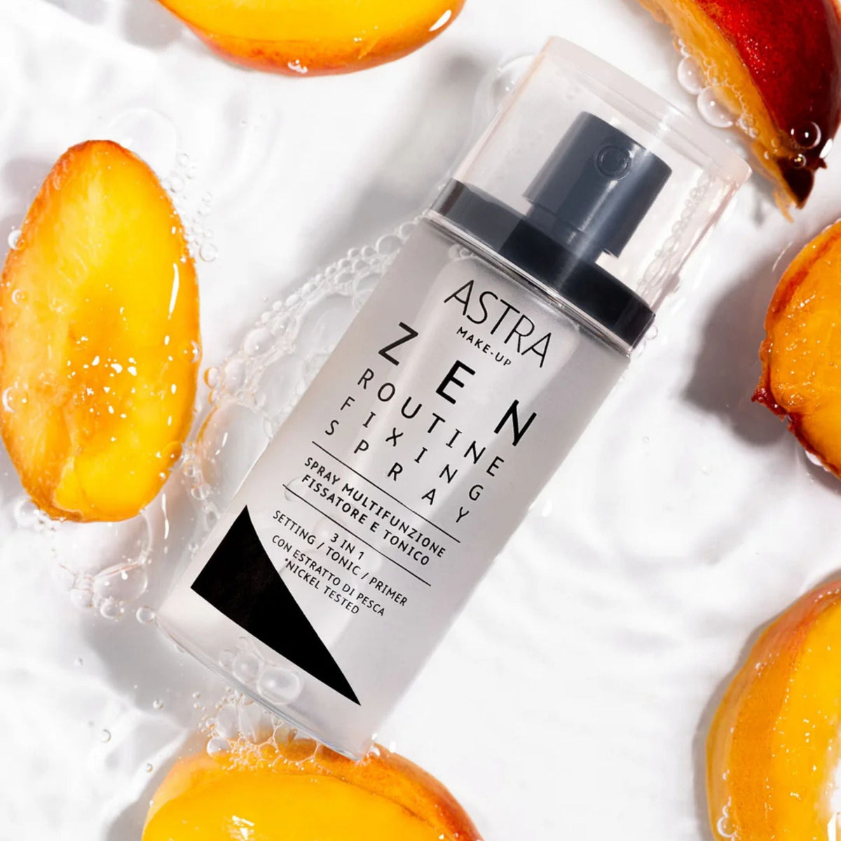Refect Beauty Astra Zen Routine Fixing Spray bottle surrounded by fresh peach slices and water droplets