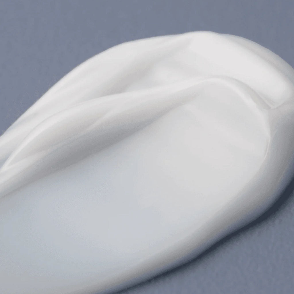 Refect Beauty AXIS-Y TXA 2.5% Intensive Brightening Cream texture swatch showing a smooth white moisturizing balm